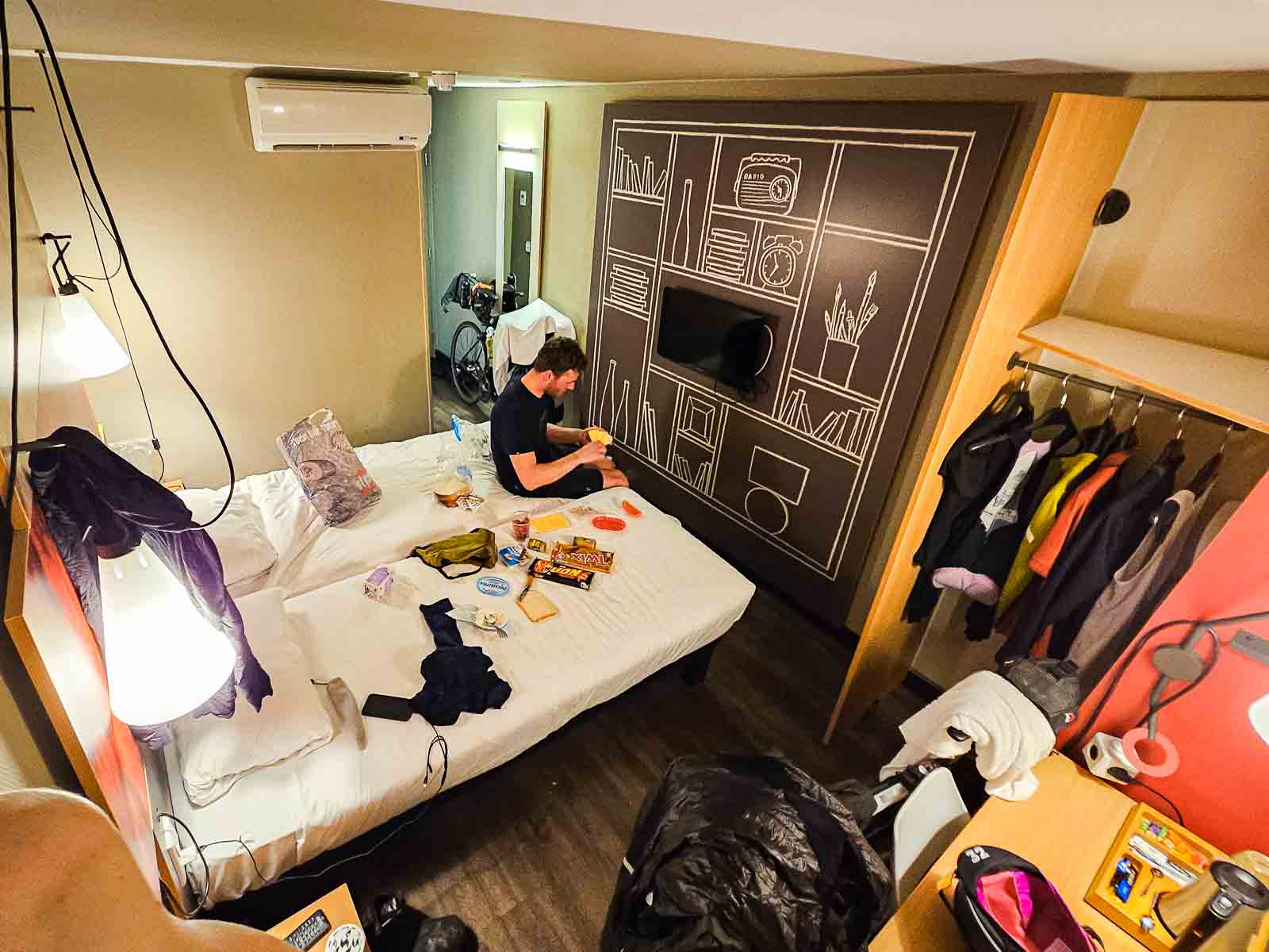 A hotel room of two participants in the Race around the Netherlands is filled with bikes, food and clothing
