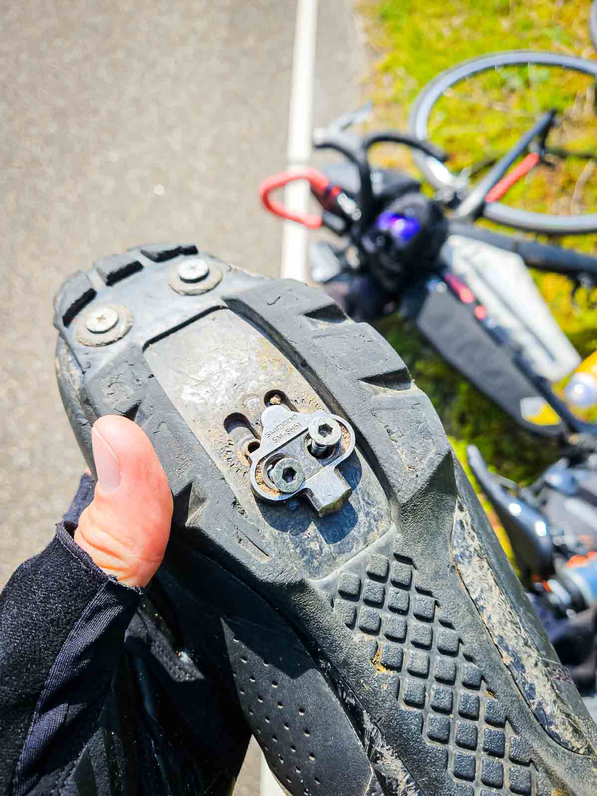 A loose cleat plate with loose screws on a wheel shoe